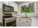 Updated kitchen showcasing modern stainless steel range and faux window view at 4061 Preserve Trl, Snellville, GA 30039