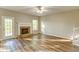 Bright living room featuring wood floors, fireplace, and access to an outdoor deck at 4061 Preserve Trl, Snellville, GA 30039