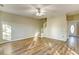 Bright living room featuring wood floors, neutral paint, a ceiling fan, and a staircase at 4061 Preserve Trl, Snellville, GA 30039