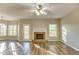 Bright living room with wood floors, fireplace, multiple windows, and view to the outside at 4061 Preserve Trl, Snellville, GA 30039