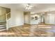 Open-concept living room featuring wood floors, staircase, and a view to the kitchen at 4061 Preserve Trl, Snellville, GA 30039