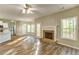 Spacious living room featuring wood floors, fireplace, and open view to kitchen at 4061 Preserve Trl, Snellville, GA 30039