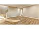 Open living room with modern flooring, neutral walls, and a staircase leading to upper floors at 4061 Preserve Trl, Snellville, GA 30039