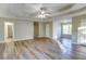 Spacious main bedroom featuring wood-look floors, a ceiling fan and tray ceilings at 4061 Preserve Trl, Snellville, GA 30039
