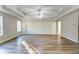 Spacious main bedroom featuring wood-look floors, a ceiling fan and tray ceilings at 4061 Preserve Trl, Snellville, GA 30039