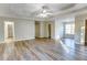 Spacious main bedroom featuring wood-look floors, a ceiling fan and tray ceilings at 4061 Preserve Trl, Snellville, GA 30039