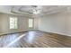 Spacious main bedroom featuring wood-look floors, two windows, a ceiling fan and tray ceilings at 4061 Preserve Trl, Snellville, GA 30039