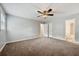 Large bedroom with neutral carpet and access to the ensuite bathroom at 1152 Bailing Dr, Lawrenceville, GA 30043