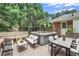 Private backyard oasis with a hot tub, patio furniture, and lush greenery, perfect for outdoor entertaining and relaxation at 5306 Corinth Cir, Stone Mountain, GA 30087