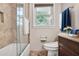 Neutral bathroom features a tiled shower-tub combo and vanity with a marble countertop at 5306 Corinth Cir, Stone Mountain, GA 30087