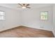 Bright, airy bedroom featuring light wood floors, neutral walls, and a ceiling fan, creating a serene retreat at 5306 Corinth Cir, Stone Mountain, GA 30087
