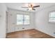 Bright bedroom features hardwood floors, a ceiling fan, and a large window providing ample natural light at 5306 Corinth Cir, Stone Mountain, GA 30087