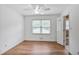 Bright bedroom features light wood floors, a ceiling fan, and convenient access to the adjacent bathroom at 5306 Corinth Cir, Stone Mountain, GA 30087