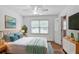 Bright bedroom featuring a comfortable bed, mounted TV, modern decor, and ample natural light through large windows at 5306 Corinth Cir, Stone Mountain, GA 30087