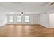 Open concept living room featuring wood-look flooring, neutral walls, and ample natural light through several large windows at 5306 Corinth Cir, Stone Mountain, GA 30087
