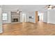 Spacious living room with wood-look flooring, fireplace, ceiling fans, and natural light, creating a warm and inviting atmosphere at 5306 Corinth Cir, Stone Mountain, GA 30087