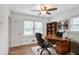 Bright office space with a ceiling fan, natural light, and a wooden desk, ideal for a productive work environment at 5306 Corinth Cir, Stone Mountain, GA 30087