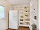 Well-organized pantry with white shelves and a refrigerator, providing ample storage for kitchen essentials and food at 5306 Corinth Cir, Stone Mountain, GA 30087