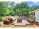 Inviting outdoor patio featuring cushioned seating, hot tub, and serene wooded backdrop for relaxation and entertainment at 5306 Corinth Cir, Stone Mountain, GA 30087