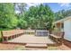 Outdoor patio showcasing ample bench seating around the perimeter, overlooking a wooded area, perfect for quiet enjoyment at 5306 Corinth Cir, Stone Mountain, GA 30087