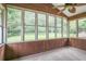 Light-filled sunroom with wood accents and expansive windows offering serene views of the outdoor surroundings at 5306 Corinth Cir, Stone Mountain, GA 30087