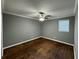 Bright bedroom with hardwood floors, gray walls, and window at , Covington, GA 30014