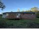 Rear exterior view of brick home featuring a wooden deck and grassy lawn at , Covington, GA 30014
