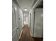 Well-lit hallway features hardwood floors, white trim, and neutral paint at , Covington, GA 30014