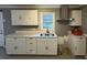 Functional kitchen features ample cabinet space, stainless steel hood, and a double sink at , Covington, GA 30014