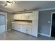 White cabinets and modern tile floors provide a sleek and functional kitchen space at , Covington, GA 30014