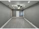 Spacious living room with gray walls, ceiling fan, and gray tile flooring at , Covington, GA 30014