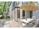 Outdoor back deck features a modern table and chairs, umbrella, and plenty of space for entertaining at 100 Little Ridge Rd, Berkeley Lake, GA 30096