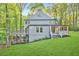 Stunning backyard view, with an upper deck, a covered porch, and a large grassy yard perfect for outdoor enjoyment at 100 Little Ridge Rd, Berkeley Lake, GA 30096