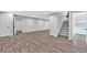 Spacious finished basement with gray wood-look flooring, neutral walls, and recessed lighting at 100 Little Ridge Rd, Berkeley Lake, GA 30096