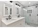 Modern bathroom featuring double sinks, white marble countertops, and a glass enclosed shower at 100 Little Ridge Rd, Berkeley Lake, GA 30096