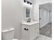 Modern bathroom featuring a white vanity with black fixtures and a tiled floor at 100 Little Ridge Rd, Berkeley Lake, GA 30096