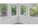 Sun-filled nook surrounded by four windows offering an immersive view of lush greenery at 100 Little Ridge Rd, Berkeley Lake, GA 30096