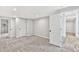Spacious bedroom with ensuite bathroom, light gray walls, and two-tone flooring at 100 Little Ridge Rd, Berkeley Lake, GA 30096