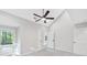 Inviting bedroom with plush carpeting, a ceiling fan, natural light, and neutral walls at 100 Little Ridge Rd, Berkeley Lake, GA 30096
