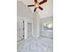 Bright bedroom featuring plush gray carpeting, light gray walls, and a unique ceiling fan at 100 Little Ridge Rd, Berkeley Lake, GA 30096