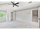 Spacious bedroom with plush carpeting, a closet, a large window, and access to the staircase at 100 Little Ridge Rd, Berkeley Lake, GA 30096