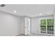 Neutrally painted bedroom with carpeted floors and a french door leading to a balcony at 100 Little Ridge Rd, Berkeley Lake, GA 30096