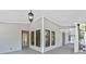 Spacious covered porch featuring classic lanterns, ample natural light, and neutral color palette at 100 Little Ridge Rd, Berkeley Lake, GA 30096