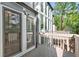 View from deck featuring the screened porch and large backyard windows at 100 Little Ridge Rd, Berkeley Lake, GA 30096