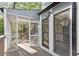 The screened porch is visible through a window from an open back deck area at 100 Little Ridge Rd, Berkeley Lake, GA 30096