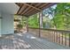 Spacious wooden deck overlooking a serene, wooded backyard, perfect for outdoor entertaining at 100 Little Ridge Rd, Berkeley Lake, GA 30096