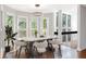 Bright dining room features hardwood floors, six chairs and scenic views from multiple windows at 100 Little Ridge Rd, Berkeley Lake, GA 30096