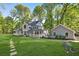 Charming two-story home with a lush green lawn and a stepping stone walkway at 100 Little Ridge Rd, Berkeley Lake, GA 30096