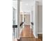 Hallway features hardwood floors, white trim, unique railing and lots of natural light from surrounding windows at 100 Little Ridge Rd, Berkeley Lake, GA 30096