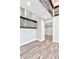 Bright hallway featuring wood-look floors and dark wrought iron handrails at 100 Little Ridge Rd, Berkeley Lake, GA 30096
